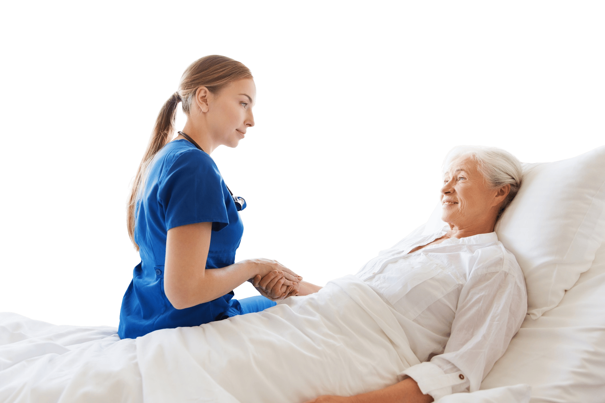 A nurse in blue scrubs holds an elderly woman's hand in a hospital bed, showing caring and medbridge training.