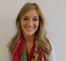 A smiling person with long blonde hair and a colorful scarf represents medbridge healthcare training professionals.