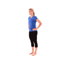 A person in a blue shirt and black pants performs a side lunge to demonstrate mobility, analogous to medbridge's hybrid care flexibility.