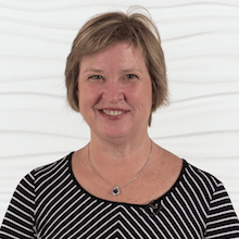 A smiling person in a striped top represents the future of healthcare education, against a white background, for Medbridge.
