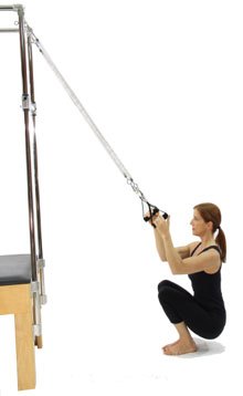 A person squats with a resistance band and equipment, illustrating strength training in medbridge's digital healthcare.
