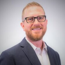 A confident man with glasses and a light beard represents medbridge's future in hybrid healthcare education.