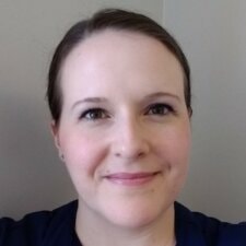 A person with short dark hair, smiling gently in a dark shirt, represents the modern ethos of digital healthcare by medbridge.