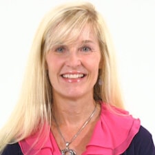 A person with long blond hair in a black top with a pink collar represents medbridge's digital healthcare innovation.