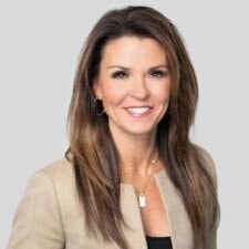 A woman with long brown hair, wearing a beige blazer, represents the innovative spirit of digital healthcare for medbridge.