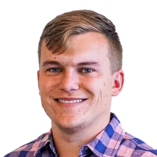 A smiling person with short hair in a plaid shirt represents digital healthcare for medbridge.