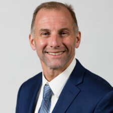 A man in a blue suit represents Medbridge's professionalism in digital healthcare.
