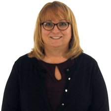 A smiling woman with glasses and blonde hair represents healthcare education for medbridge.