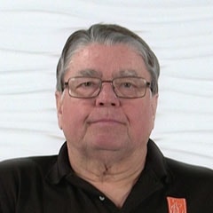 An older adult in glasses and a black shirt represents medbridge's hybrid digital healthcare solutions.
