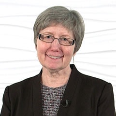 A person with short gray hair and glasses stands against a white background, suggesting expertise in healthcare education or medbridge software.