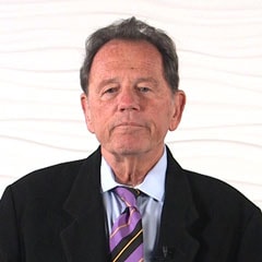 An elderly man in a black suit and striped tie represents Medbridge's shift to digital healthcare.