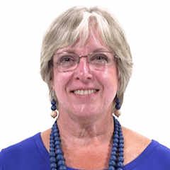 Older woman in blue attire smiling, representing digital healthcare's future with medbridge.