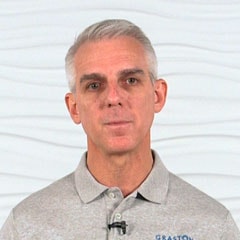 A professional man with gray hair in a collared shirt represents healthcare training expertise with medbridge patient care software.