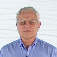 A person with short gray hair and glasses in a blue collared shirt represents the digital healthcare shift that medbridge embodies.