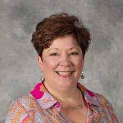A smiling person in a colorful shirt represents medbridge's commitment to healthcare innovation against a gray backdrop.