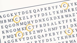 A word search puzzle on wood with letters circled in yellow, featuring "C" and "X," from medbridge.