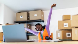 Warehouse employee stretching at desk, highlighting the role of advanced primary care in workplace musculoskeletal health.