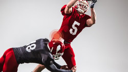 Medbridge players: red #5 leaps for a catch as black #18 attempts a tackle.