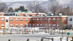 A rural critical access hospital in winter with snow-covered grounds, meeting critical access hospital requirements to serve remote communities.