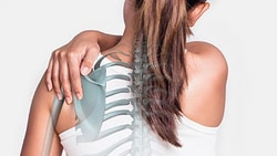 A woman with a ponytail holds her shoulder, overlaid with an illustration of her spine and ribcage for medbridge.