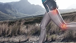 A person runs outside with a digital overlay of muscles and joints, set against hills in the background for medbridge.