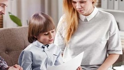 A family reviews documents with an advisor in a bright office.