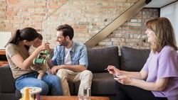 Pediatric occupational therapist coaching parents and child at home during a family-centered therapy session