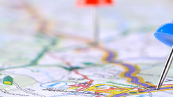 Map with red and blue push pins indicating specific locations.
