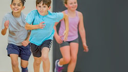 Children running energetically inside a gym.