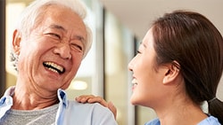 Smiling patient and clinician sharing a moment of connection, illustrating positive communication and patient satisfaction in healthcare.