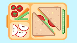 Lunchbox with triangle sandwiches, cucumbers, tomatoes, carrots, and apples on a light blue background.