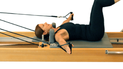 Individual using a Pilates reformer at medbridge.