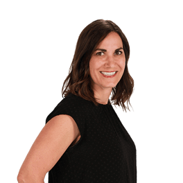 Smiling woman with brown hair and a black top, against a plain background.