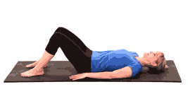 A person performs a bridge exercise on a yoga mat, symbolizing the core-strengthening benefits of hybrid care in medbridge's healthcare education.
