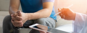 A man attentively listens during a digital healthcare consultation using medbridge.