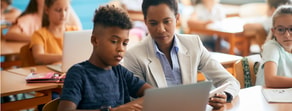 A teacher helps a student with digital healthcare tools in a Medbridge hybrid care classroom.