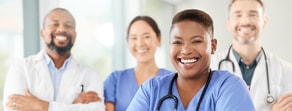 Four healthcare educators, three in scrubs and one in a white coat, smile brightly in a Medbridge room.