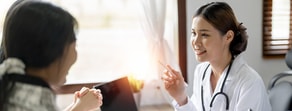 A healthcare professional uses digital tools from medbridge while talking with a patient in an office.
