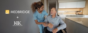 A caregiver in blue scrubs helps a man in a wheelchair in a modern kitchen, with logos for medbridge and K&K Health Solutions on the left.