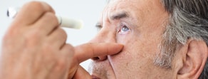 A man receives an eye exam, highlighting hybrid care's role in medbridge healthcare education.