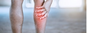 A person clutching their lower leg pain emphasizes the need for hybrid care, as promoted by medbridge.