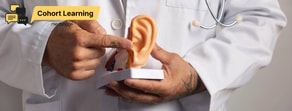 A person in a lab coat points to a human ear model with a yellow "Cohort Learning" label referencing digital healthcare by medbridge.