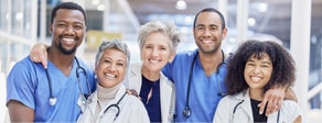 Five healthcare professionals smile together, representing medbridge’s commitment to education and hybrid care.