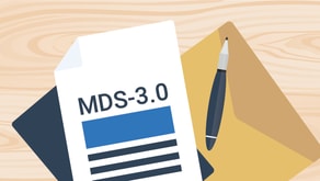 A document labeled "MDS-3.0" lies beside a pen and folder on wood, highlighting Medbridge’s healthcare focus.
