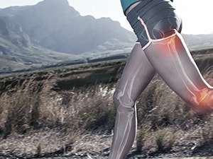 A person runs outside with a digital overlay of muscles and joints, set against hills in the background for medbridge.