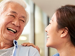 Smiling patient and clinician sharing a moment of connection, illustrating positive communication and patient satisfaction in healthcare.