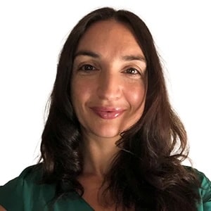 Smiling person with long brown hair in a green top; medbridge.