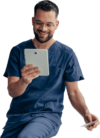 A person in blue scrubs smiles, holding a tablet and a medbridge card.