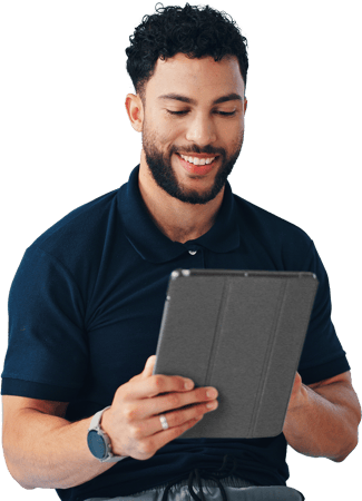 A man smiles at a tablet while exploring medbridge patient care software.