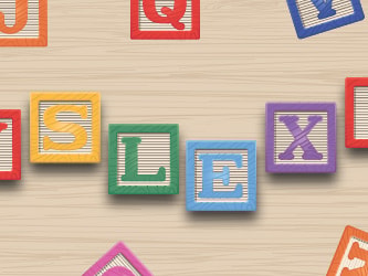 Toy blocks spell "Dyslexia" on wood amidst scattered letter blocks.
